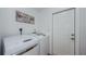 Bright laundry room featuring modern washer and dryer and decorative wall art at 14534 Yacht Club Blvd, Seminole, FL 33776