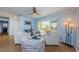 Comfortable living room featuring stylish furniture, a ceiling fan, and large windows, offering ample natural light at 14534 Yacht Club Blvd, Seminole, FL 33776