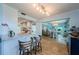 Open-concept living space with a breakfast bar, dining area, and hardwood floors in a brightly painted home at 14534 Yacht Club Blvd, Seminole, FL 33776