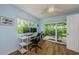 Office area with hardwood floors, two computer monitors, a white desk, and direct access to the patio at 14534 Yacht Club Blvd, Seminole, FL 33776