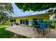 Back patio with brick pavers, barbecue, and dining set, perfect for outdoor entertainment at 14534 Yacht Club Blvd, Seminole, FL 33776