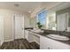 Bathroom featuring double sinks, granite countertop, with wood-look vinyl flooring at 14819 Summer Branch Dr Dr, Lithia, FL 33547