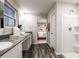 Bathroom featuring double sinks, granite countertop, with wood-look vinyl flooring at 14819 Summer Branch Dr Dr, Lithia, FL 33547