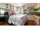 Sports-themed bedroom with large bed, striped accent wall, and unique football decor at 14819 Summer Branch Dr Dr, Lithia, FL 33547