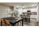 Modern kitchen and dining area features white cabinets, stainless steel appliances, and island seating at 14819 Summer Branch Dr Dr, Lithia, FL 33547