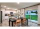 Dining room with backyard views, and modern kitchen with white cabinets and stainless appliances at 14819 Summer Branch Dr Dr, Lithia, FL 33547