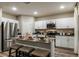 Modern kitchen features white cabinets, stainless steel appliances, a kitchen island with seating at 14819 Summer Branch Dr Dr, Lithia, FL 33547