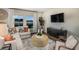 Cozy living room with large windows, comfortable seating, area rug, and modern decor at 14819 Summer Branch Dr Dr, Lithia, FL 33547