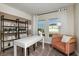 Bright office space with modern white desk, stylish chair and decorative shelving with view to outside at 14819 Summer Branch Dr Dr, Lithia, FL 33547
