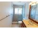Bright bathroom features a glass-enclosed shower and modern vanity with sink at 15028 Redcliff Dr, Tampa, FL 33625