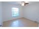 Bedroom with ceiling fan and bright window at 15028 Redcliff Dr, Tampa, FL 33625