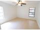 A bright bedroom features neutral tile, fan, and a window with great natural light at 15028 Redcliff Dr, Tampa, FL 33625