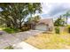 Charming single-story home featuring a driveway, garage, and beautifully landscaped yard at 15028 Redcliff Dr, Tampa, FL 33625