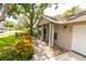 Charming home with an attached garage, decorative landscaping, and cozy front porch at 15028 Redcliff Dr, Tampa, FL 33625