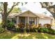 Charming home with an attached garage, decorative landscaping, and a cozy covered porch at 15028 Redcliff Dr, Tampa, FL 33625