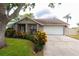 Charming home with a two-car garage, colorful landscaping, and a cozy front porch at 15028 Redcliff Dr, Tampa, FL 33625