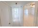Bright hallway leading to rooms and the living area with tile floors at 15028 Redcliff Dr, Tampa, FL 33625