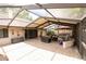 Expansive screened patio with ample seating, hot tub, and a durable brick paver floor at 15028 Redcliff Dr, Tampa, FL 33625