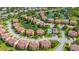 Neighborhood aerial showcasing neatly arranged homes, picturesque ponds, and a community pool at 1536 Ember Ln, Tarpon Springs, FL 34689