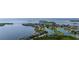 Stunning aerial view of waterfront homes nestled along the coastline and a tranquil lagoon at 1536 Ember Ln, Tarpon Springs, FL 34689