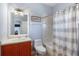 Bathroom featuring a vanity with a sink, a toilet, and a shower with a shower curtain at 1536 Ember Ln, Tarpon Springs, FL 34689