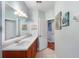 Bathroom featuring tile floors, vanity, and view to hallway at 1536 Ember Ln, Tarpon Springs, FL 34689