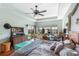 Bedroom with ceiling fan, hard wood floors, and views of the lake at 1536 Ember Ln, Tarpon Springs, FL 34689
