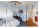 Bedroom featuring wood floors, a television, and access to the bathroom at 1536 Ember Ln, Tarpon Springs, FL 34689