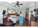Bedroom with hard wood floors and a ceiling fan at 1536 Ember Ln, Tarpon Springs, FL 34689