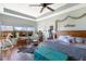 Bedroom with a ceiling fan and hard wood floors at 1536 Ember Ln, Tarpon Springs, FL 34689