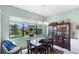 Cozy dining room with natural light, a large window, and classic furniture for intimate gatherings at 1536 Ember Ln, Tarpon Springs, FL 34689
