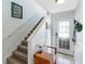 Inviting entryway featuring a staircase, wainscoting, and a charming welcome area at 1536 Ember Ln, Tarpon Springs, FL 34689