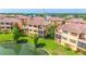 A building with multiple balconies overlooking the pond and lush greenery at 1536 Ember Ln, Tarpon Springs, FL 34689