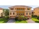 Beautiful three-story townhome featuring a two-car garage and well-maintained landscaping at 1536 Ember Ln, Tarpon Springs, FL 34689