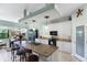 Bright kitchen with granite countertops, modern appliances, and an island with bar stool seating at 1536 Ember Ln, Tarpon Springs, FL 34689