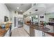 Bright and modern kitchen with granite counters, a central island with seating, and stainless steel appliances at 1536 Ember Ln, Tarpon Springs, FL 34689