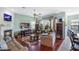 Spacious living room featuring hardwood floors, a fireplace, and access to an outdoor screened-in lanai at 1536 Ember Ln, Tarpon Springs, FL 34689