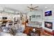 Bright living room featuring hardwood floors, a fireplace, and an open floor plan leading to the kitchen at 1536 Ember Ln, Tarpon Springs, FL 34689