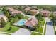 Aerial view showcasing the community pool, clubhouse, and manicured landscaping at 1536 Ember Ln, Tarpon Springs, FL 34689