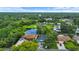 Aerial view of a home near a tranquil pond with lush surrounding trees and landscape at 1609 Haven Bnd, Tampa, FL 33613