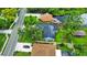 Aerial view of the home, showing solar panels on the roof and a lush, green surrounding neighborhood at 1609 Haven Bnd, Tampa, FL 33613