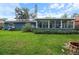 Spacious backyard with a screened-in lanai and solar panels on the roof at 1609 Haven Bnd, Tampa, FL 33613
