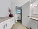 Bathroom boasting granite countertops, modern white cabinetry, and a shower, offering style and function at 1609 Haven Bnd, Tampa, FL 33613