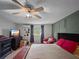 Comfortable bedroom with a plush bed, stylish furniture, ceiling fan, and a window view at 1609 Haven Bnd, Tampa, FL 33613