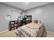 This bedroom features a patterned comforter, a computer desk, and natural light at 1609 Haven Bnd, Tampa, FL 33613