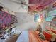 This psychedelic bedroom features a ceiling fan, canopy, decorative vines, and unique art at 1609 Haven Bnd, Tampa, FL 33613