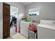 The laundry room features a washer, dryer, and window at 1609 Haven Bnd, Tampa, FL 33613