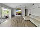 Bright living area with wood floors, modern furnishings, and a seamless flow to the outdoor sunroom at 1609 Haven Bnd, Tampa, FL 33613