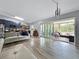 Open floor plan with hardwood floors, modern kitchen, and an inviting sunroom at 1609 Haven Bnd, Tampa, FL 33613