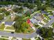 An aerial view showcases a charming home with a well-maintained lawn on a corner lot at 1715 Larabie Ct, Brandon, FL 33511